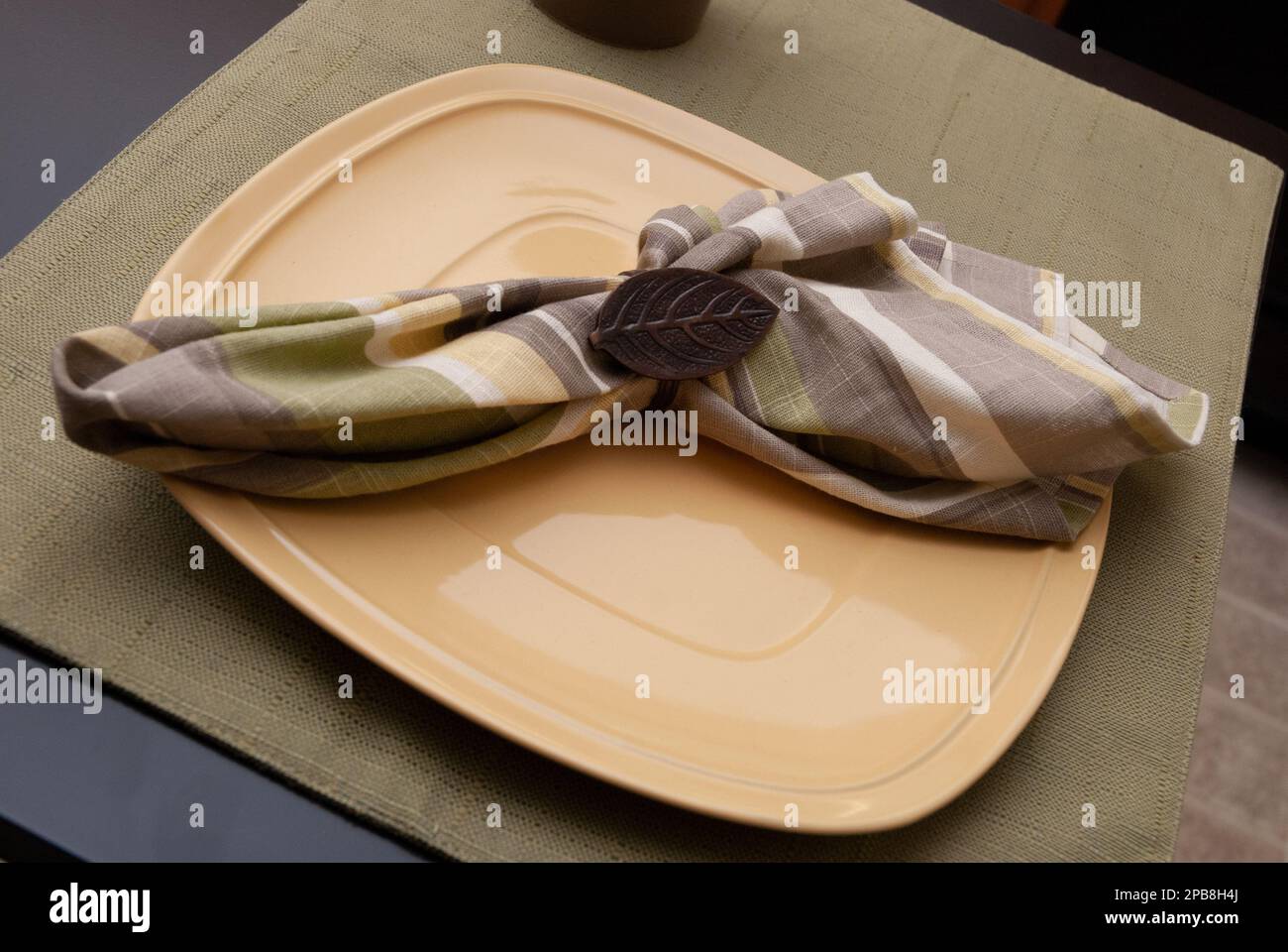 Eine einfache, informelle Tischdecke mit Tischset, Teller, Serviette und Serviettenring Stockfoto
