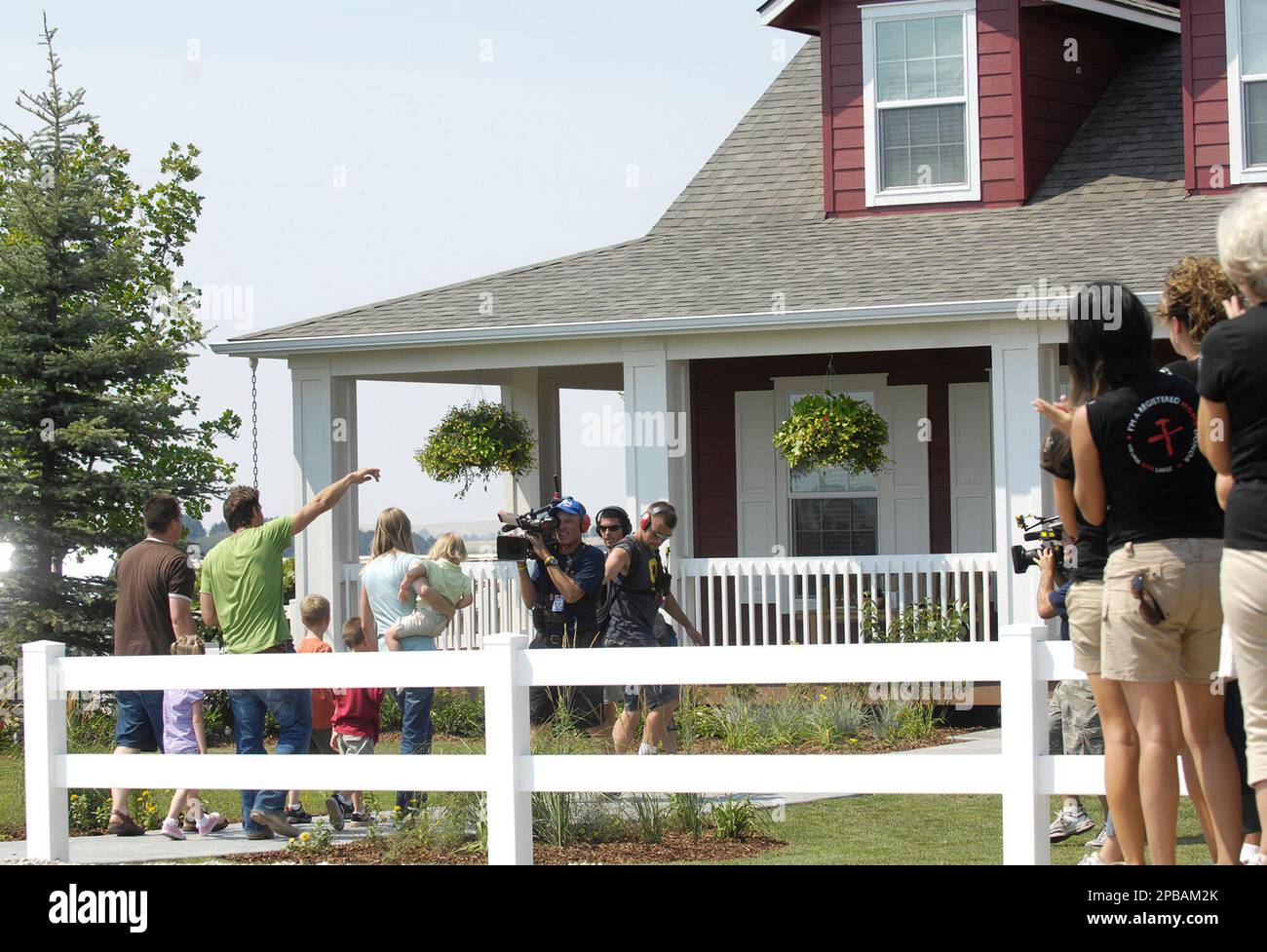 Ryan and Karia Stockdale and their four children walk up to their new