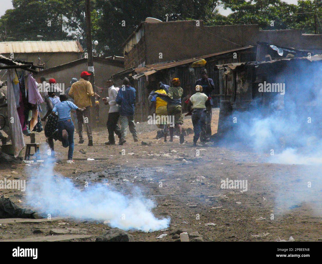Mathare slum residents run from tear gas fired by police Wednesday ...