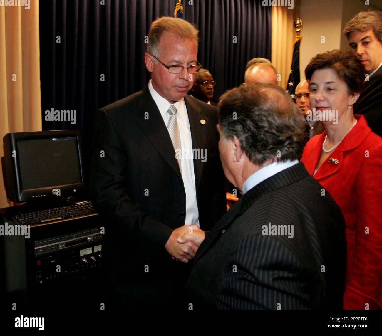 Mark J. Mershon from the FBI, left, Queens County District Attorney
