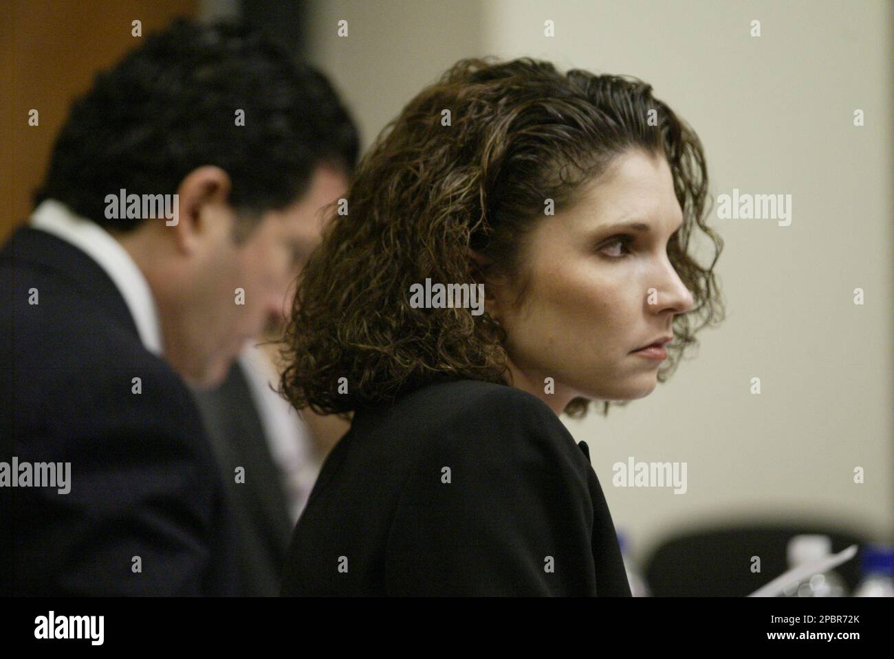 Melanie McGuire, right, is shown during her trial in a courtroom in New