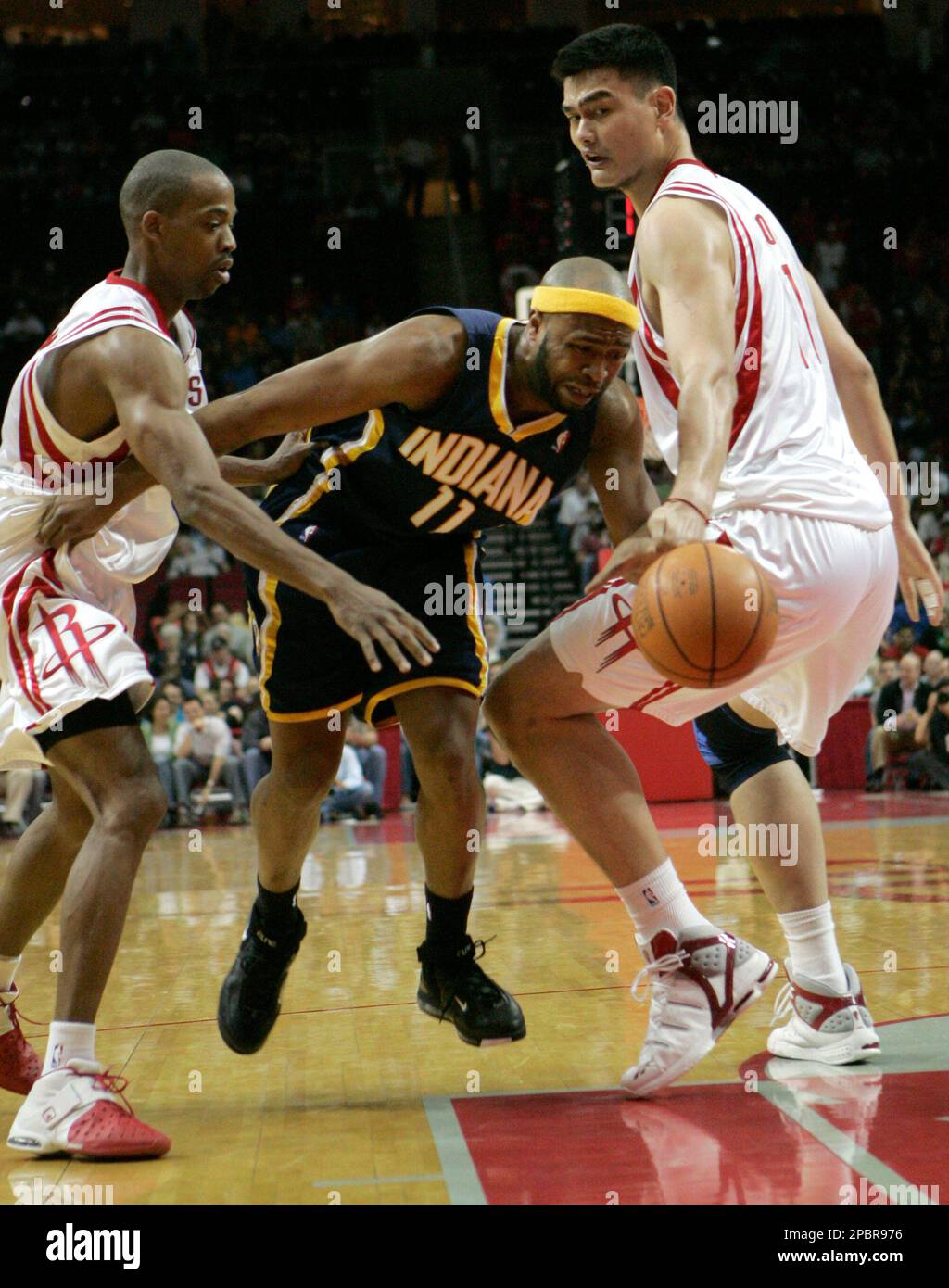 Indiana Pacers' Jamaal Tinsley, center, tries to move the ball past ...