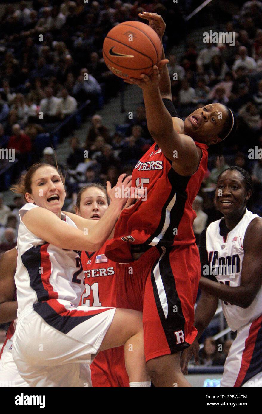Rutgers' Kia Vaughn tries to pull in a rebound as she battles with