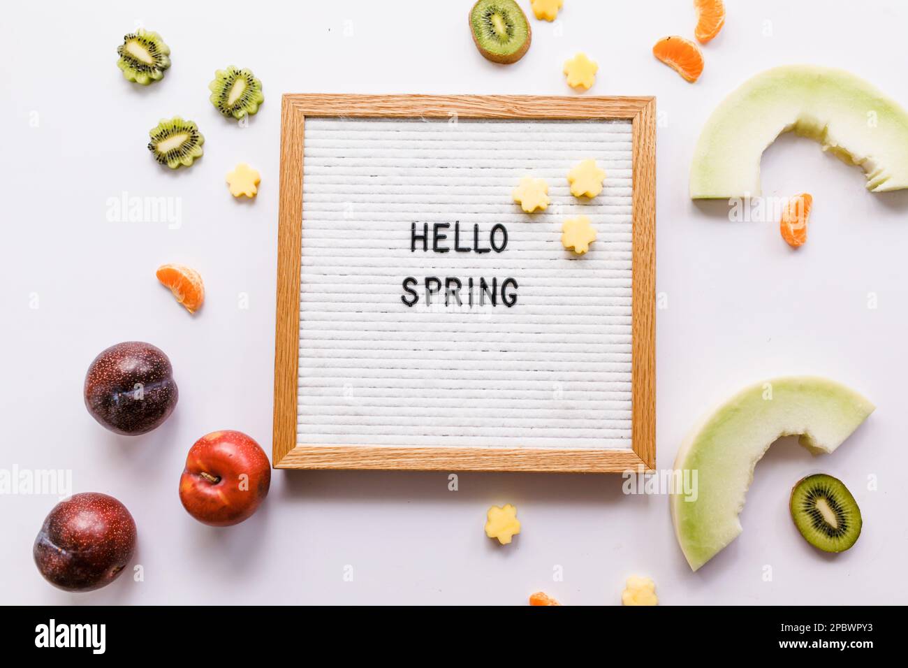 Hello Spring Zitat-Brett mit frischen Früchten Stockfoto