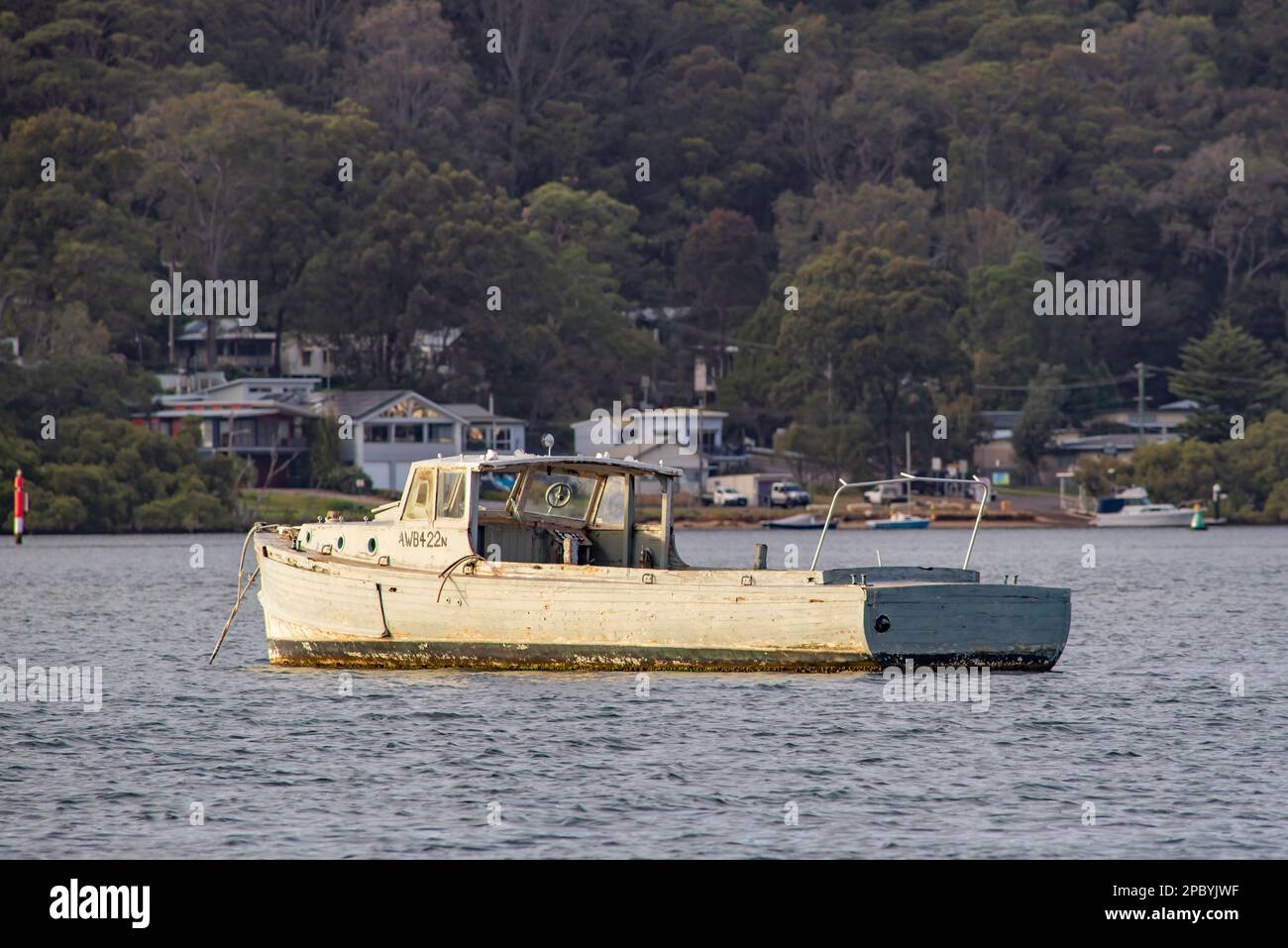 Ehemaliges Arbeitsboot der Armee aus dem 2. Weltkrieg 40ft, AWB422, am Ettalong Beach festgemacht und etwas schlechter getragen, aber noch registriert und in Gebrauch. Stockfoto