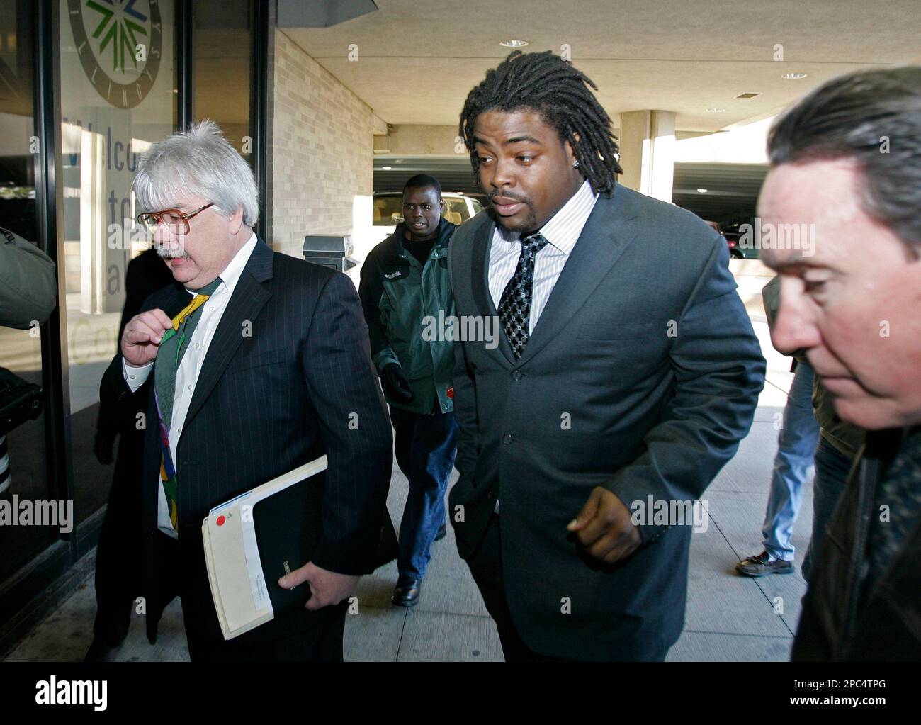 Chicago Bears defensive lineman Terry "Tank" Johnson, center, arrives