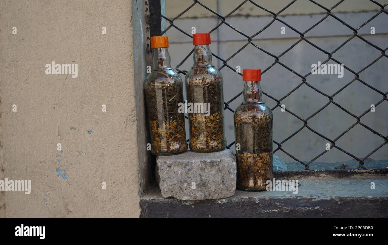 Bangalore, Karnataka, Indien-Januar 01 2023: Indische getrocknete ayurvedische Kräuter zur Verringerung des Haarfalls, die in Flaschen gelagert und in den Straßen von Shivaji nagar verkauft werden Stockfoto