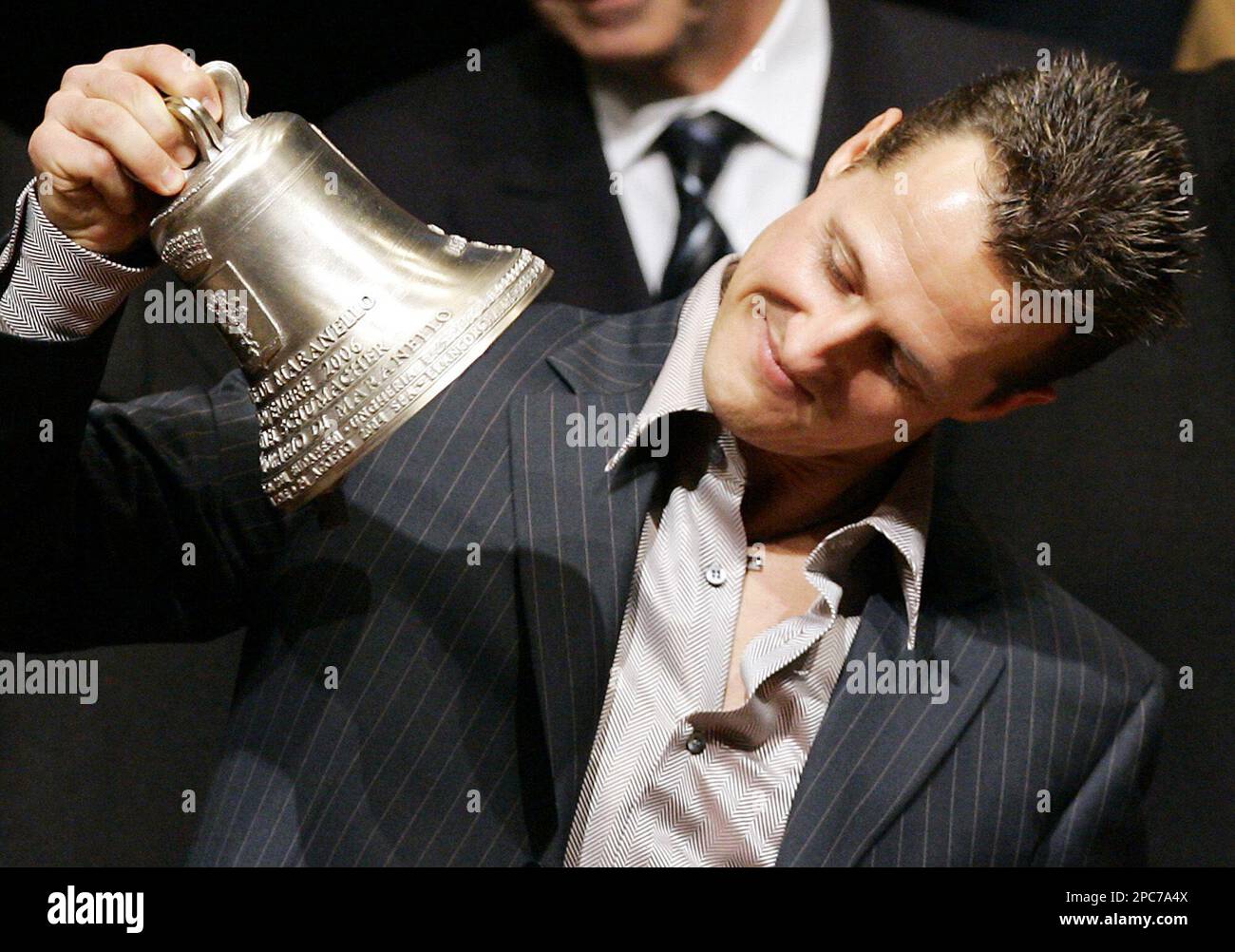 ** FOR USE WITH YEAR END - FILE **Former German Ferrari F1 driver Michael Schumacher is presented with a bell during a ceremony in Maranello, near Modena, Italy, Tuesday, Dec. 5, 2006. Schumacher was given honorary citizenship of Maranello. (AP Photo/Antonio Calanni) Stockfoto