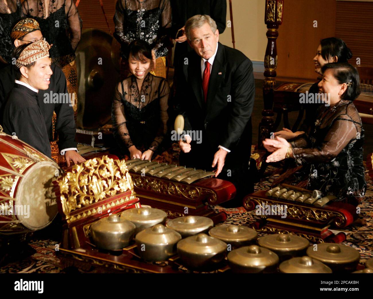 U.S. President George W. Bush, seated center, plays a traditional ...