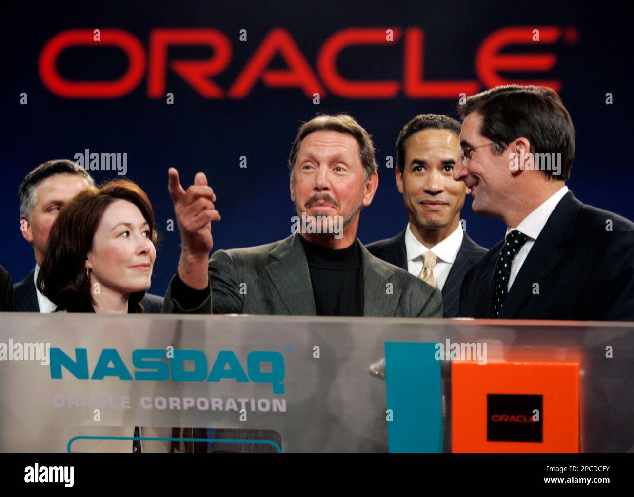 Oracle ceo larry ellison center is surrounded by oracle and nasdaq