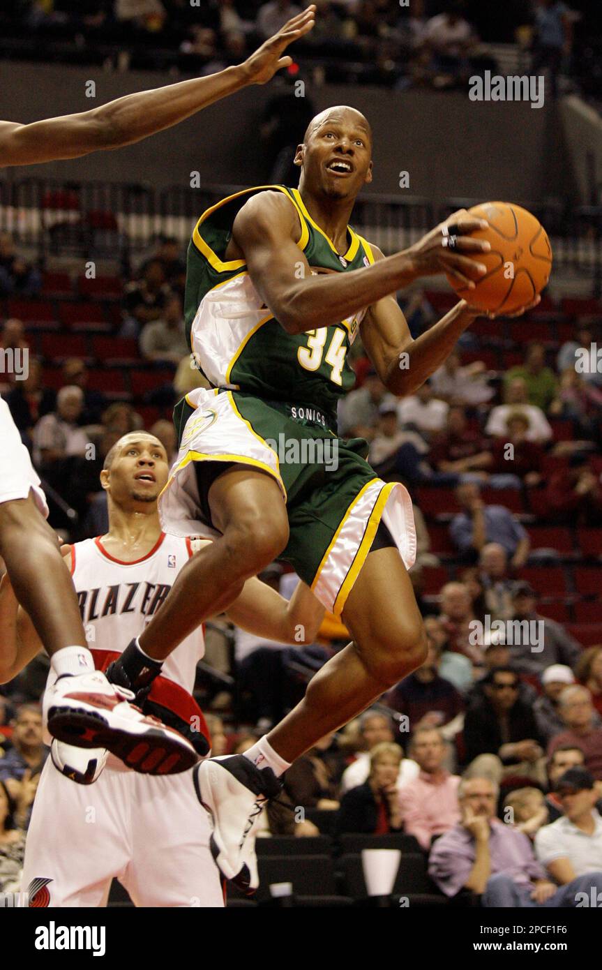 Seattle SuperSonics' Ray Allen (34) scores as Portland Trail Blazer Brandon Roy looks on in the first quarter of an NBA basketball game Wednesday, Oct. 11, 2006, in Portland, Ore. (AP Photo/Rick Bowmer) Stockfoto