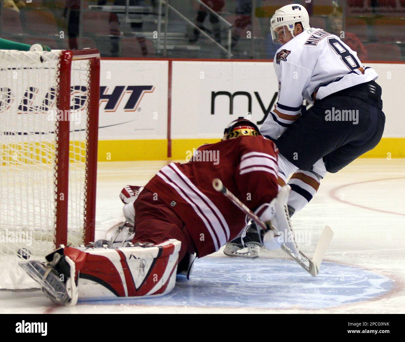 Edmonton Oilers left winger Alexei Mikhnov, right, of Russia, scores against Phoenix Coyotes goalie Mike Morrison, left, in the first period of a NHL preseason hockey game Thursday, Sept 28, 2006, in Glendale, Ariz. (AP Photo/Rick Scuteri) Stockfoto
