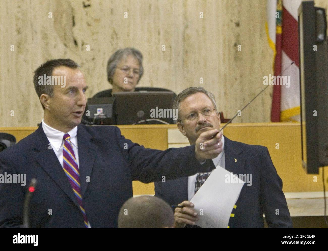 Matthew Bauer, left, testifies as Assistant State Attorney John Aguero