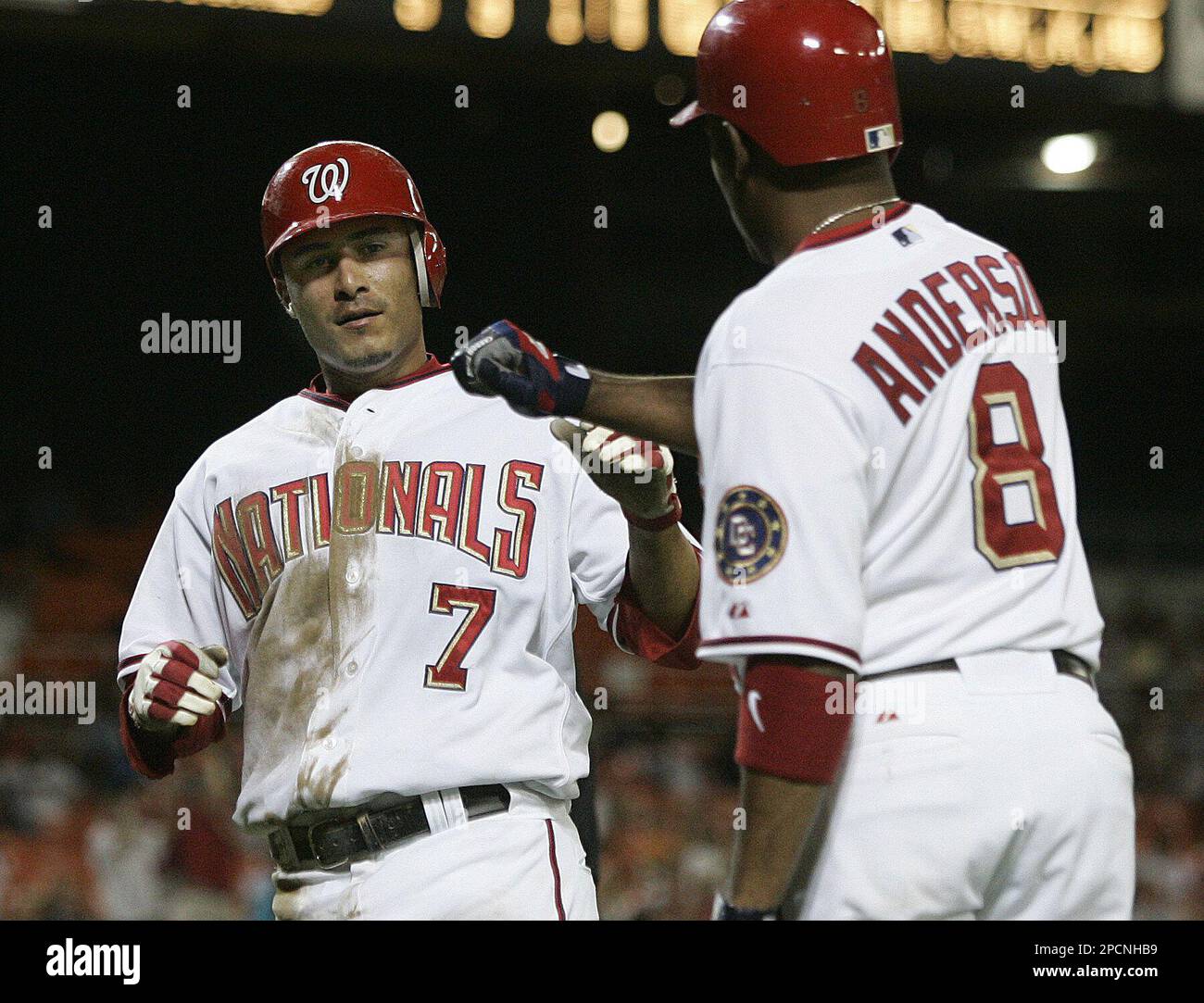 Washington Nationals' Felipe Lopez (7) is congratulated by Marlon Anderson (8) as he scores during the eighth inning of a baseball game against the Florida Marlns, Wednesday, Aug. 9, 2006, in Washington. The Nationals won 5-2. (AP Photo/Lawrence Jackson) Stockfoto