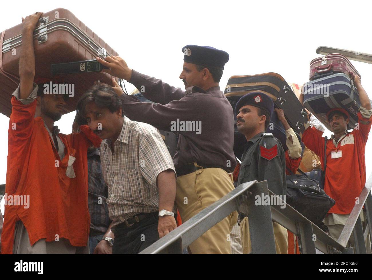 Pakistani Police Officers Check Luggage Of Passengers Carries By A pakistani-police-officers-check-luggage-of-passengers-carries-by-a