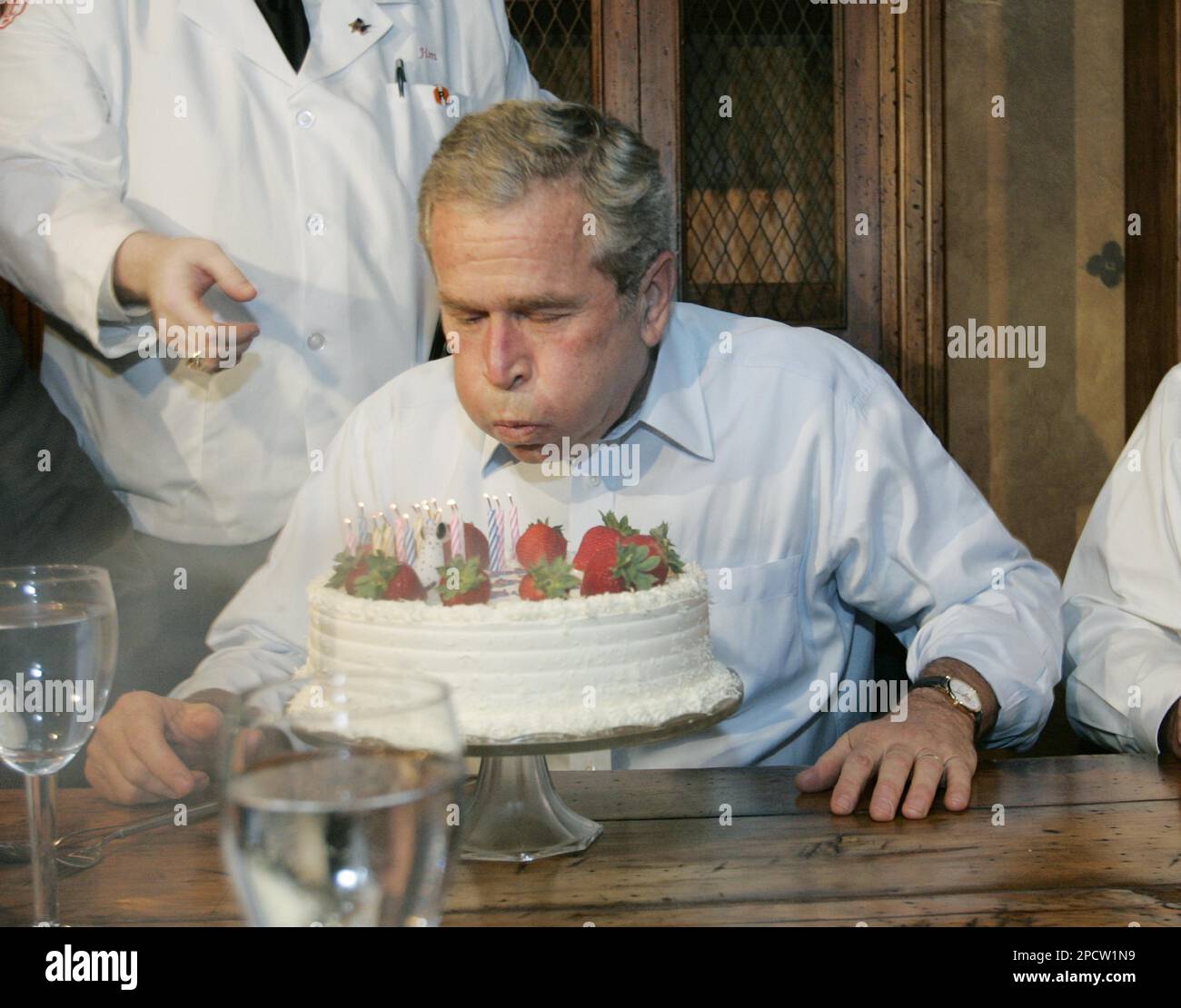 President Bush blows out the candles on his birthday cake after his dinner at at the Chicago Firehouse Thursday, July 6, 2006 in Chicago. Bush turned sixty Thursday.(AP Photo/Pablo Martinez Monsivais) Stockfoto