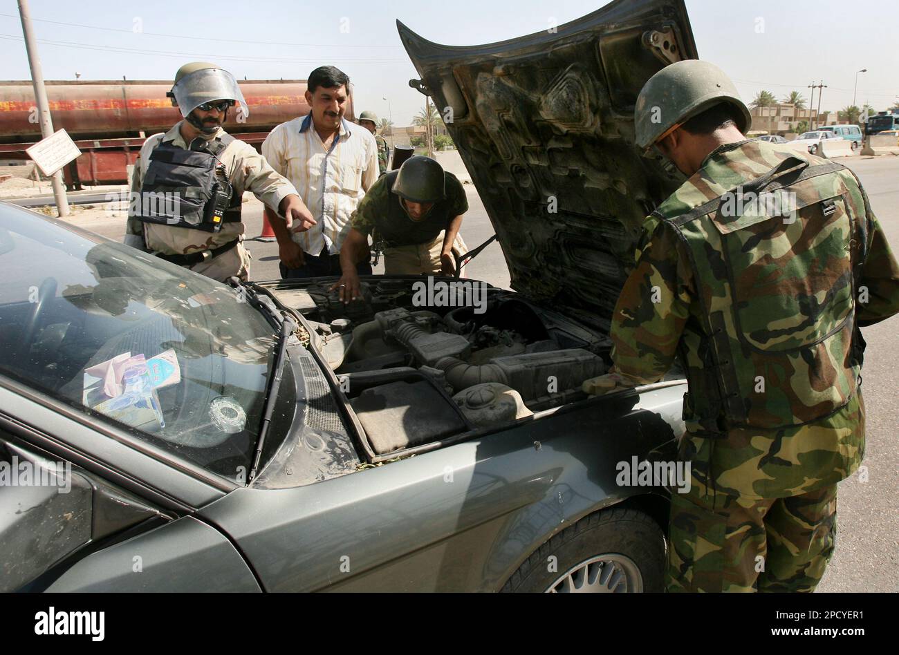 Iraqi Interior Ministry commandos search a car in the Dora neighborhood