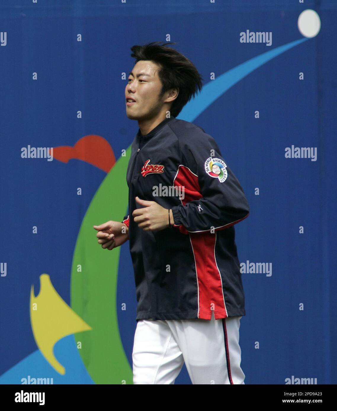 Team Japan pitcher Koji Uehara jogs along the warning track in the outfield at Petco Park during