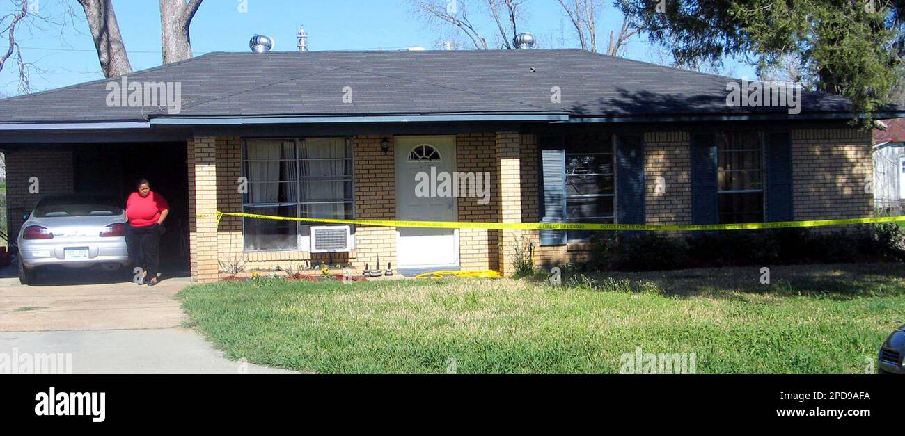 An unidentified person looks over the crime scene tape that isolates