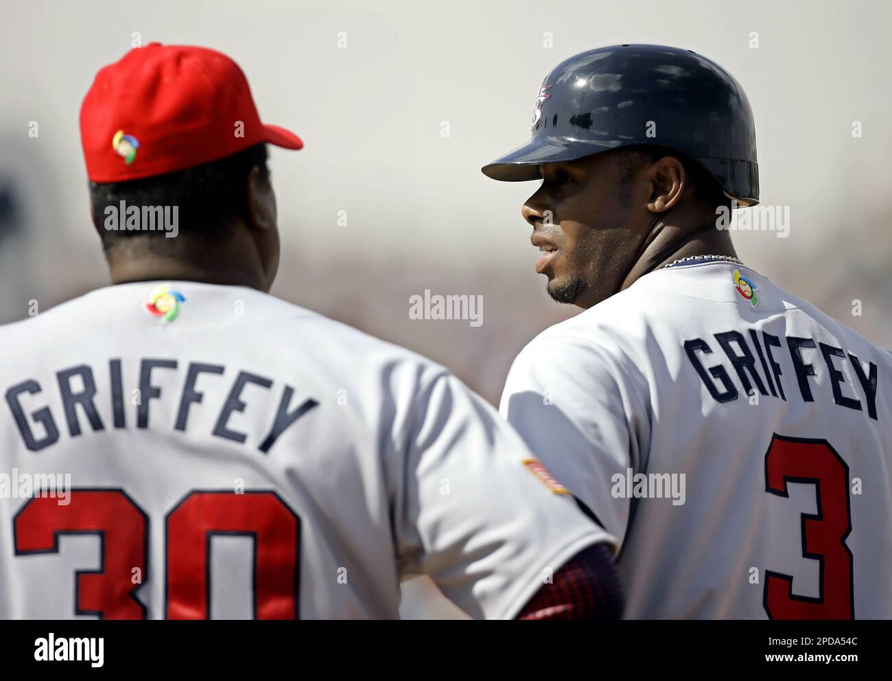 Team USA's Ken Griffey Jr., right, talks with his father, first base ...