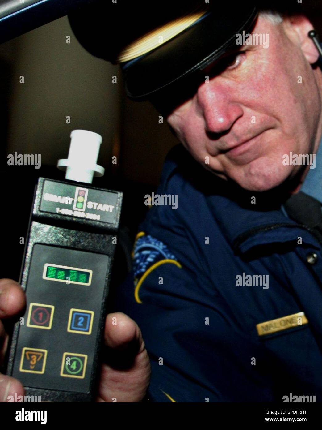 Massachusetts State Police Lt. Paul Maloney holds an Ignition Interlock