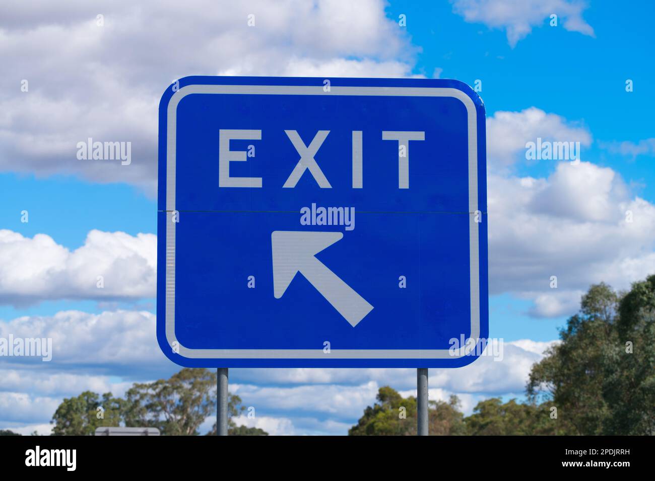 Australisches Ausfahrtsschild auf der Autobahn mit Pfeil und Richtung auf blauem metallischem Hintergrund, Victoria, Australien. Stockfoto