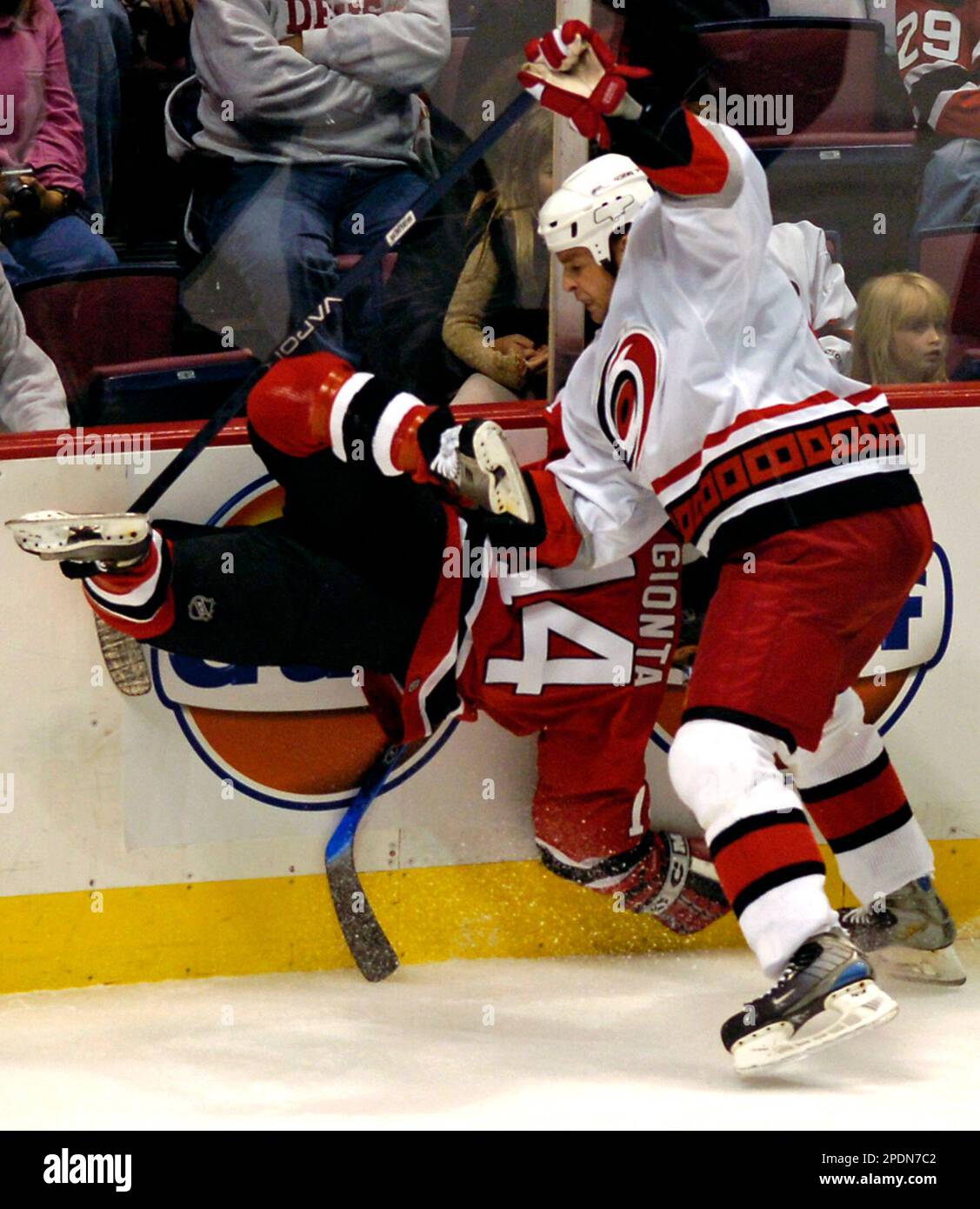 Carolina Hurricanes' Aaron ward, right, checks New Jersey Devils' Brian Gionta into the boards during the first period Saturday night, Oct. 15, 2005, in East Rutherford, N.J. (AP Photo/Bill Kostroun) Stockfoto