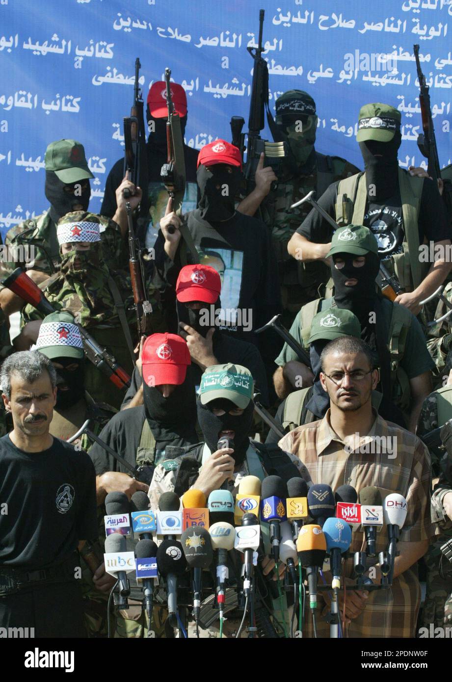 Members of eight armed Palestinian factions stand while a Hamas