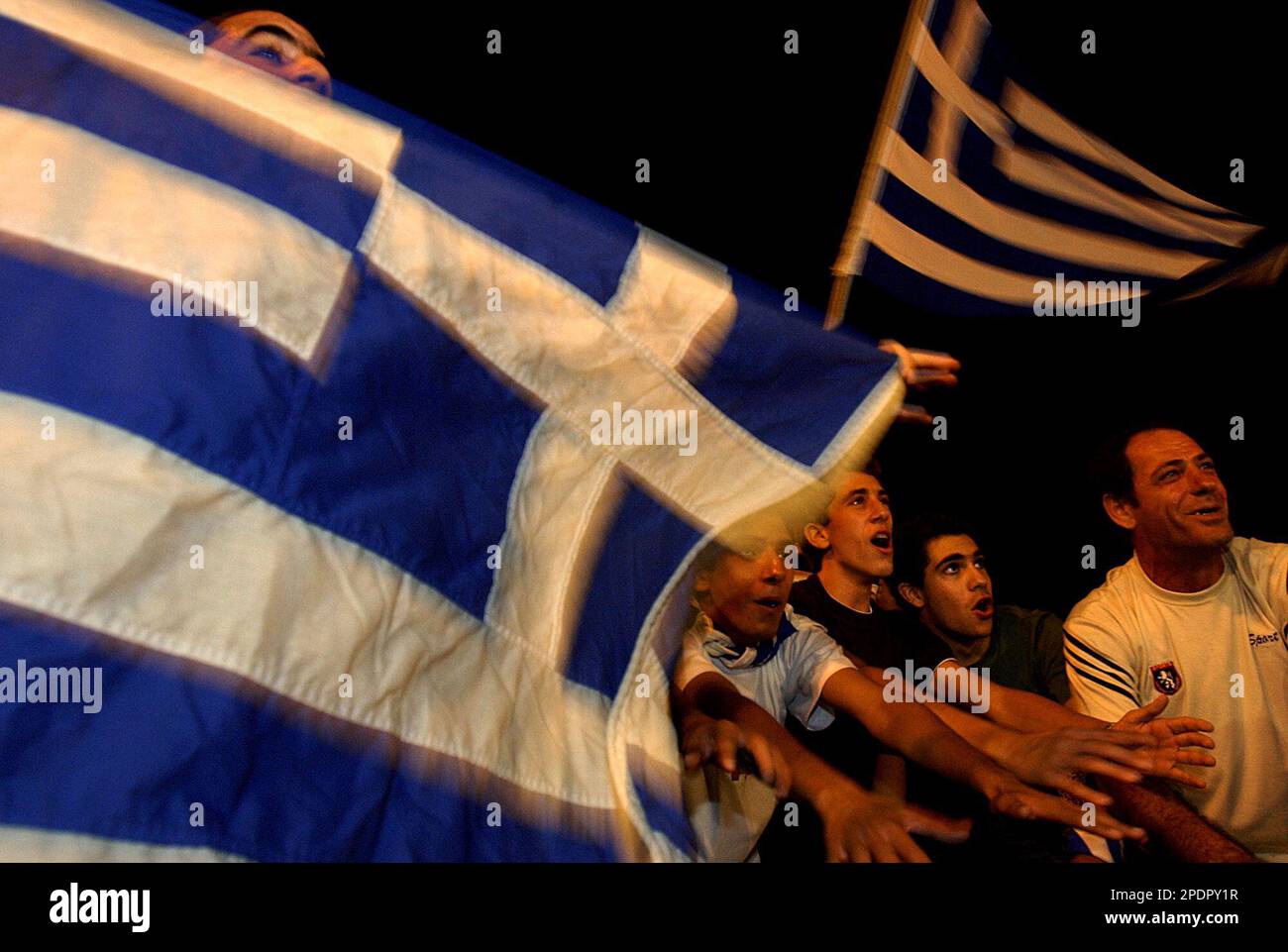 Greek Cypriot fans wave the Greek flags as celebrate in Eleftheria