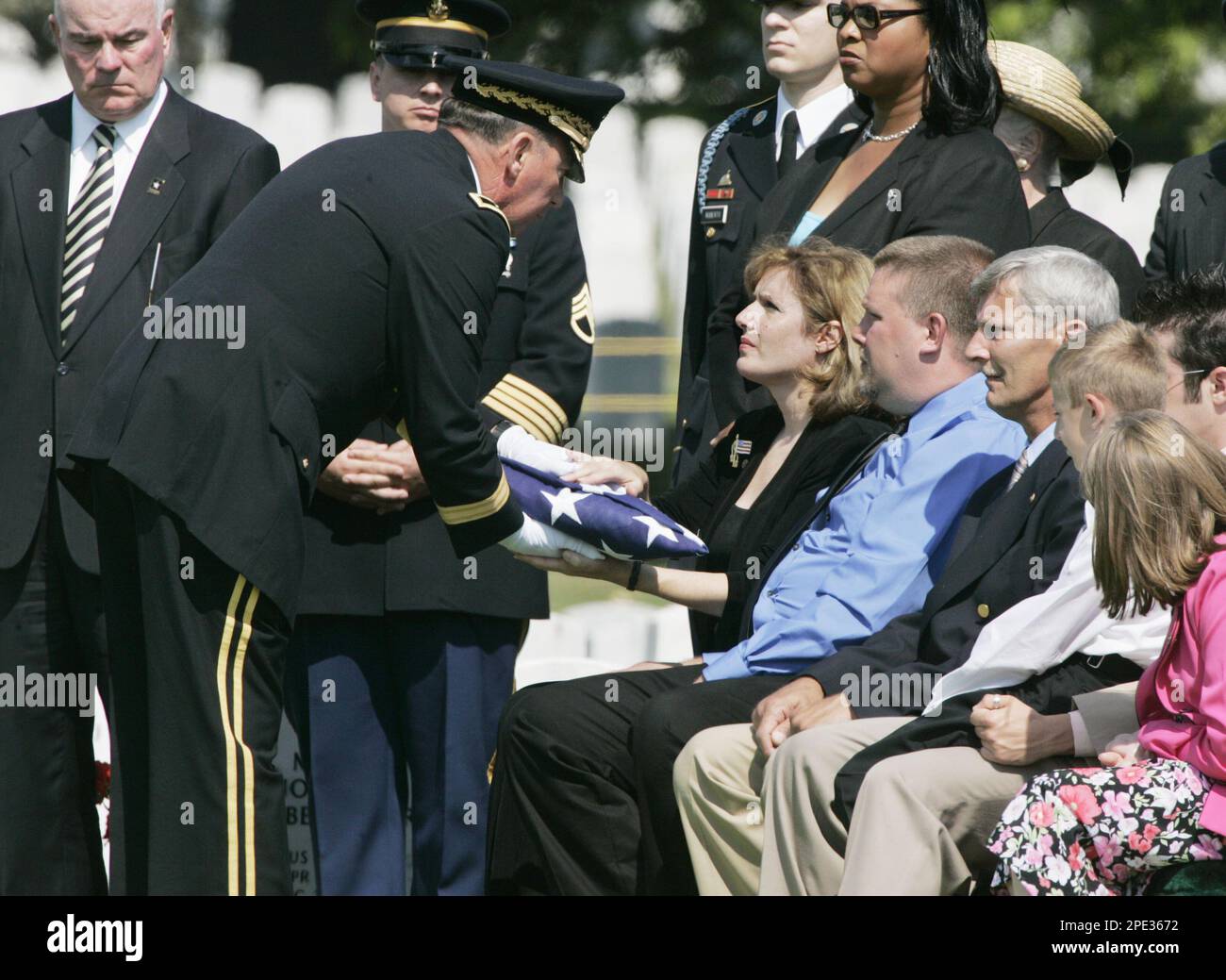 Joan Parker, center, mother of Sgt. David J. Murray, is handed the U.S