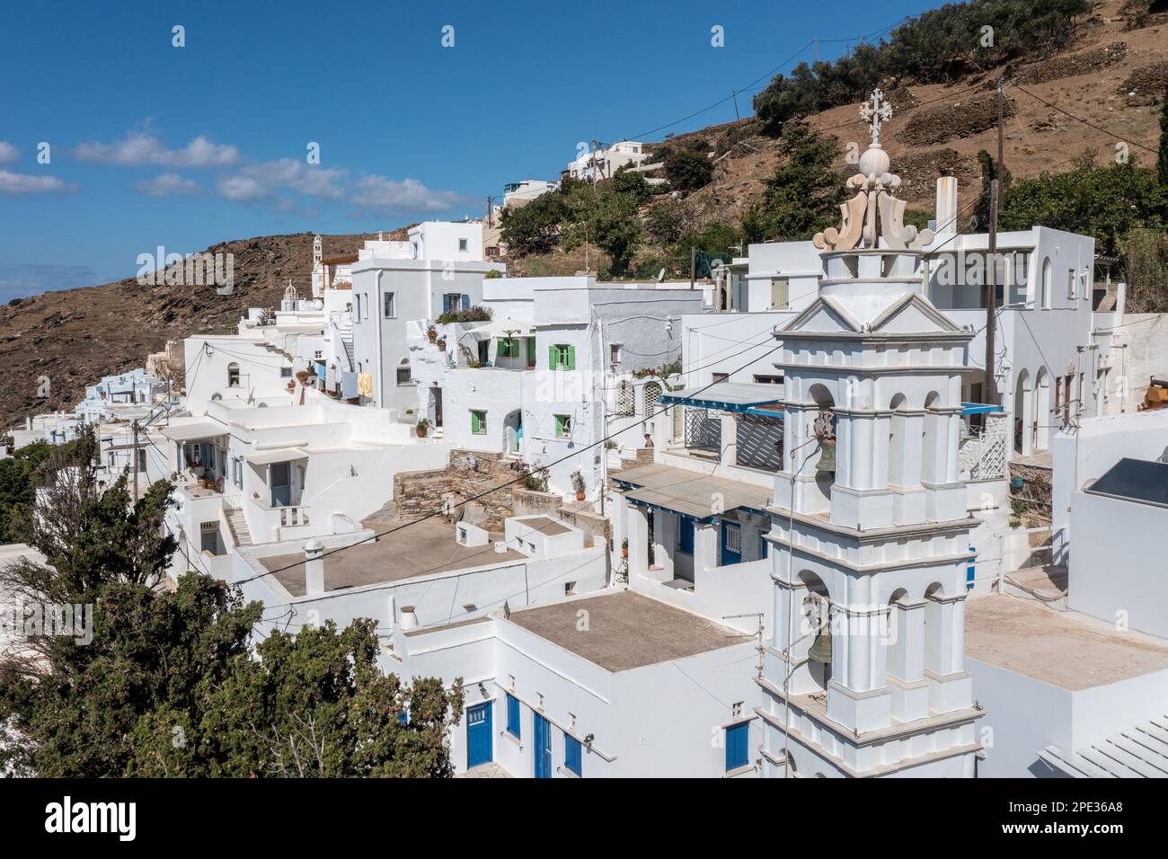 Kykladen, Griechenland. Tinos, griechische Insel, Luftblick auf das Dorf Kardiani, weiße Gebäude und Kirchenglocke, blauer Himmel Stockfoto