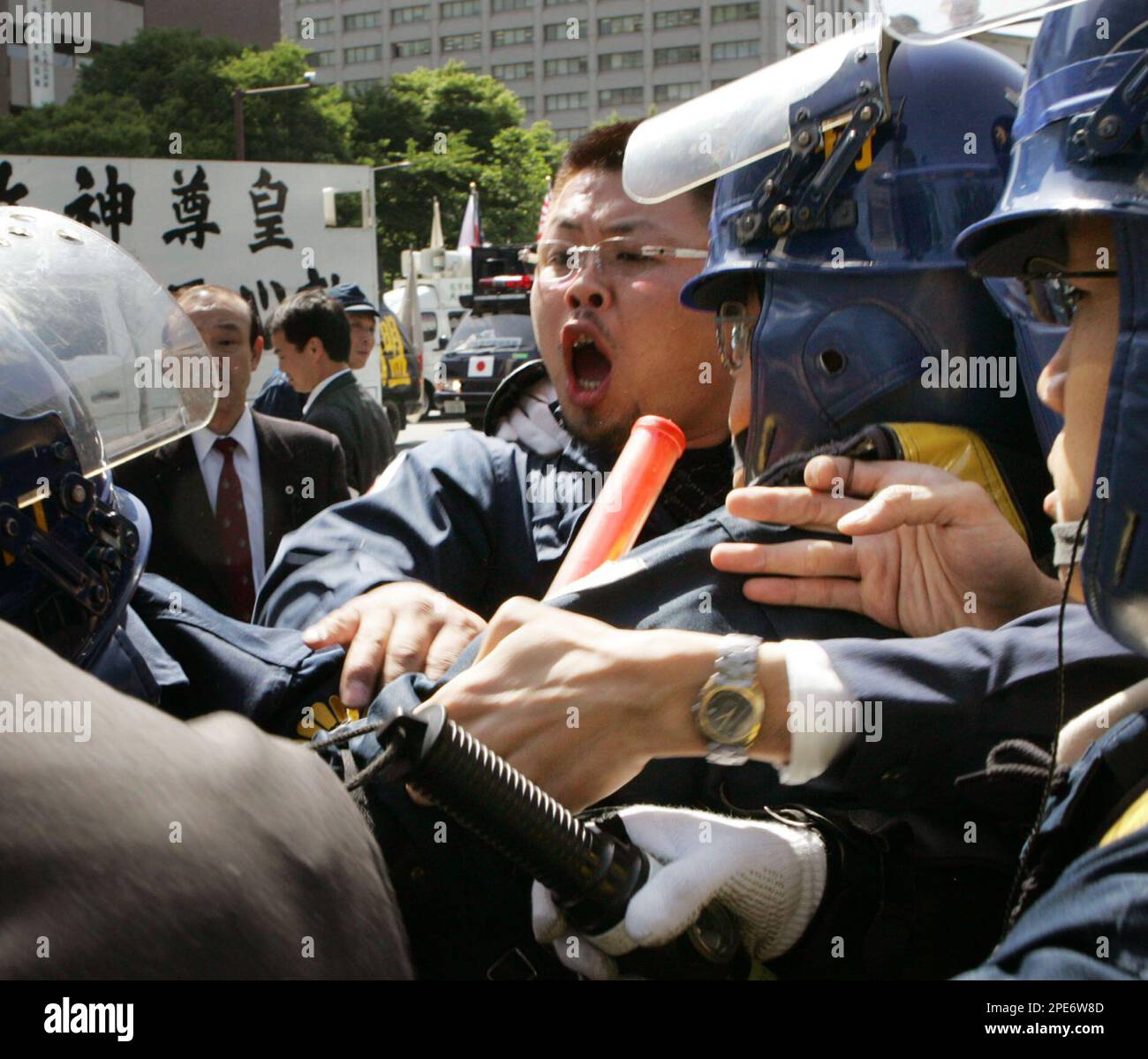 Define Riotous A rightwing activist, center, scuffles with riot police near a Tokyo ...
