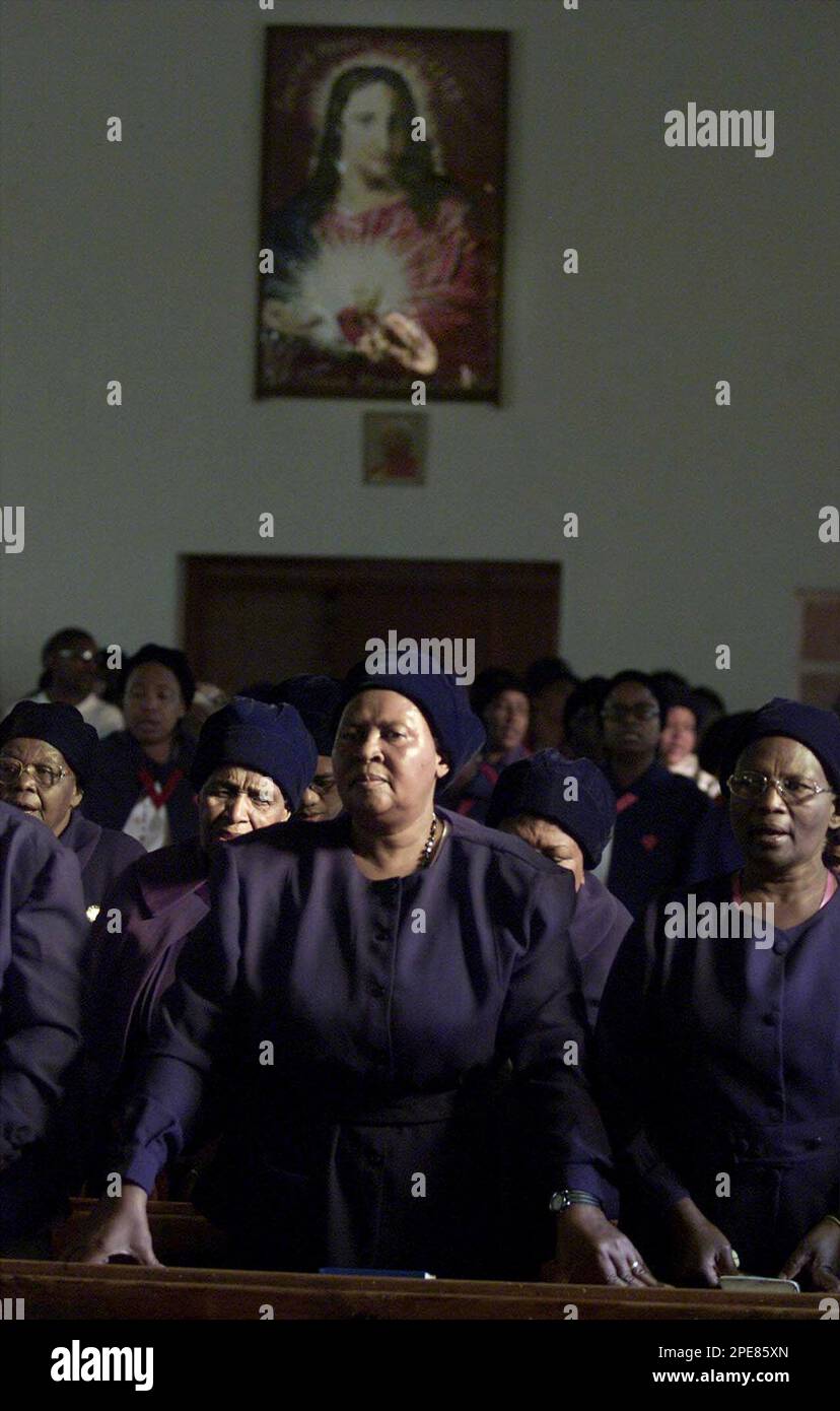 worshippers-beneath-a-portrait-of-the-sacred-heart-attend-mass-at-st