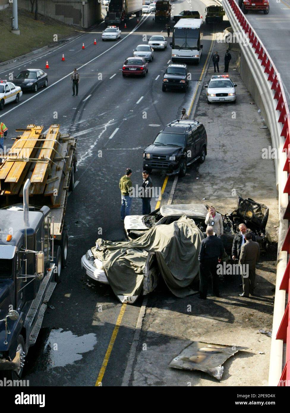Police officials investigate a multiple vehicle accident that left two ...