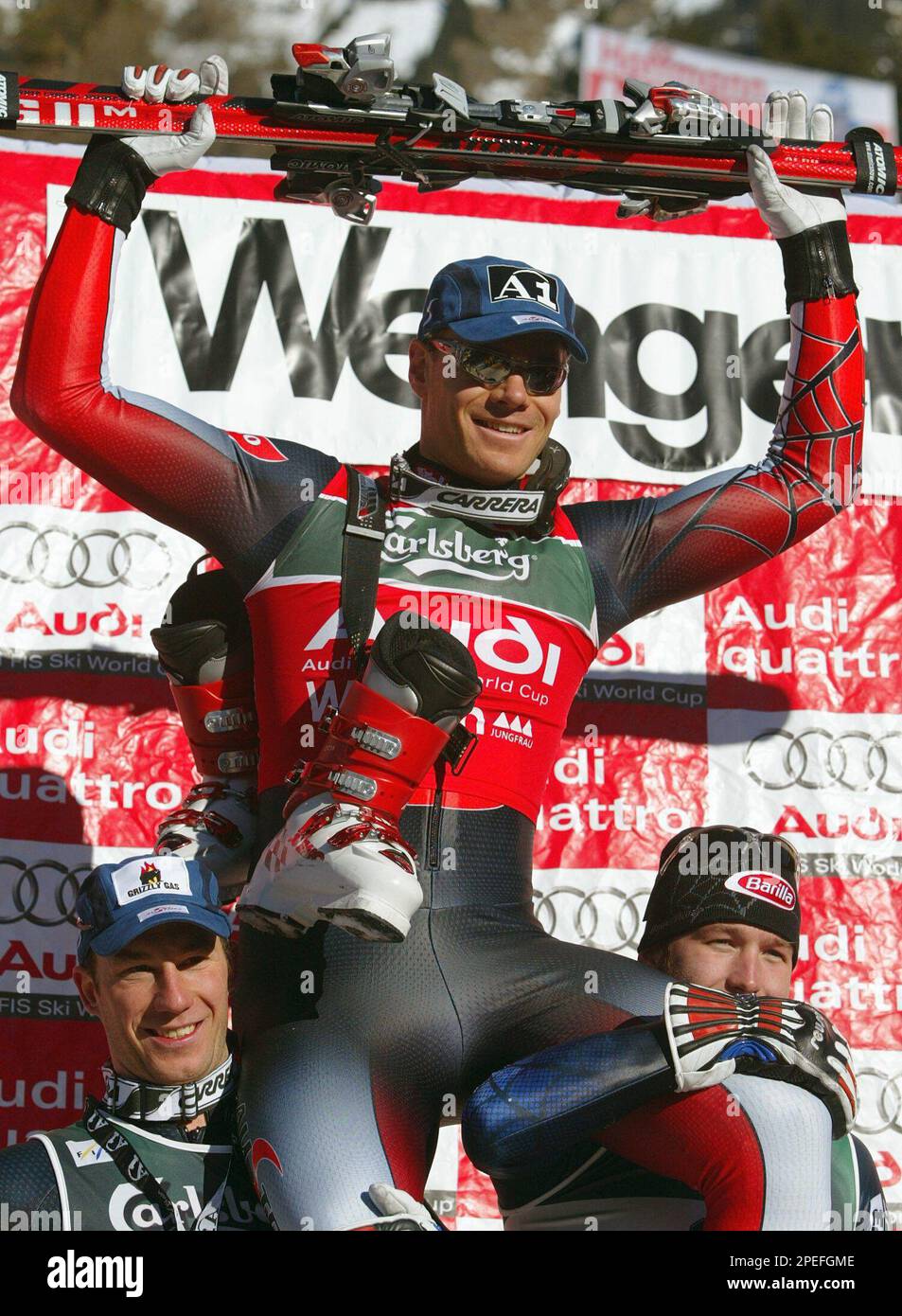 Austrian ski racer Michael Walchhofer, center, jubilates as the winner