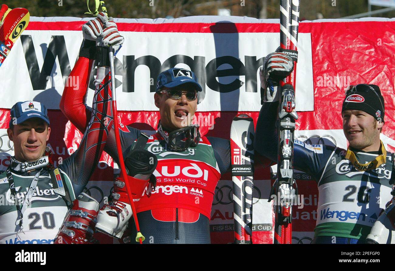 Austrian ski racer Michael Walchhofer, center, jubilates as the winner