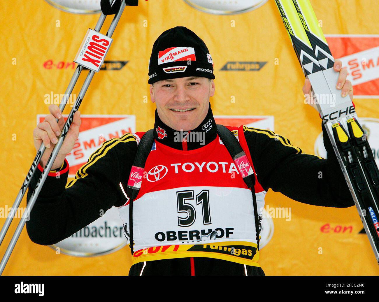 Sven Fischer, of Germany, celebrates on the podium after the men's 10 ...