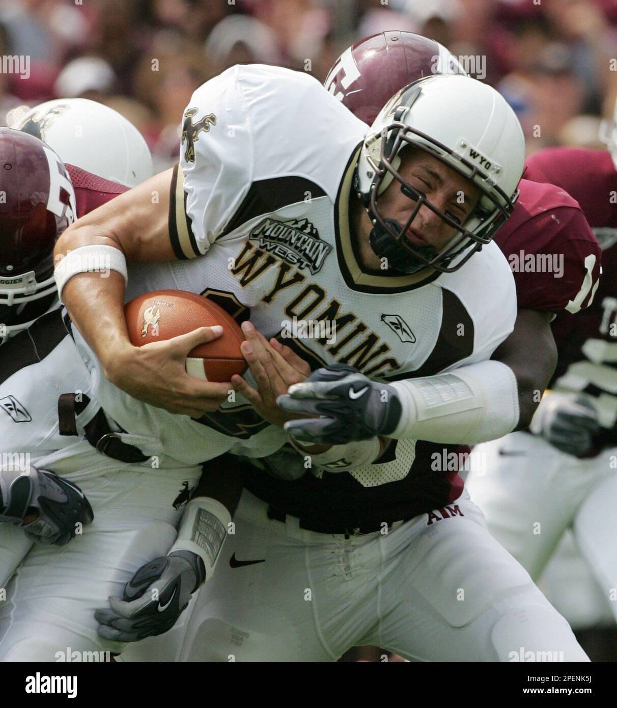 Wyoming quarterback Corey Bramlet (17) is tackled by Texas A&M's Justin Warren (10) after a gain of 4 yards during the first quarter Saturday, Sept. 11, 2004, in College Station, Texas. (AP Photo/David J. Phillip) Stockfoto