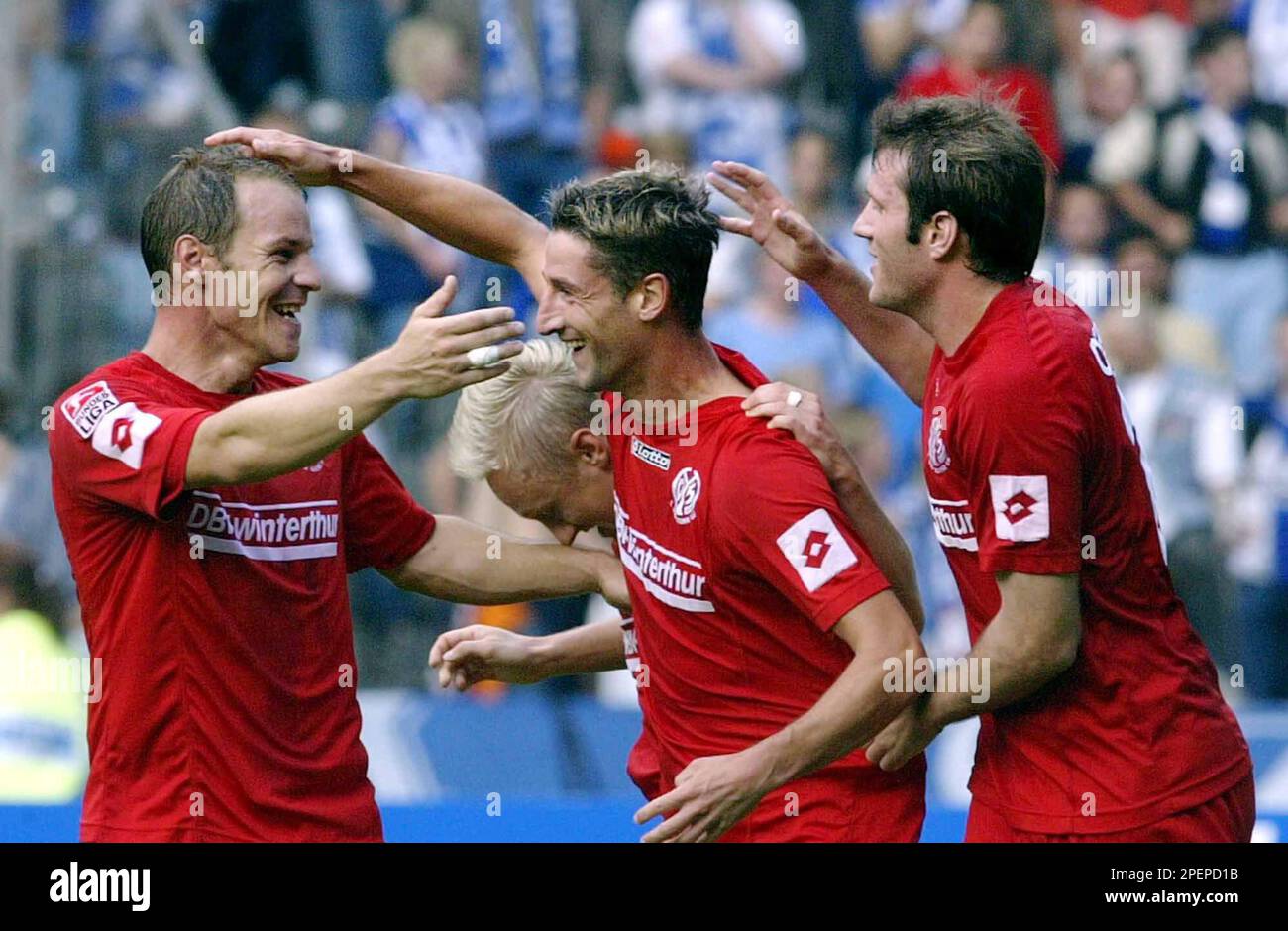 Mainz players Juergen Kramny, center, and his teammates Christof Babatz