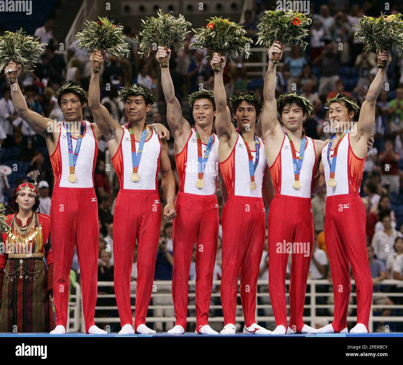 Japan's men's gymnastics team celebrates with their gold medals during