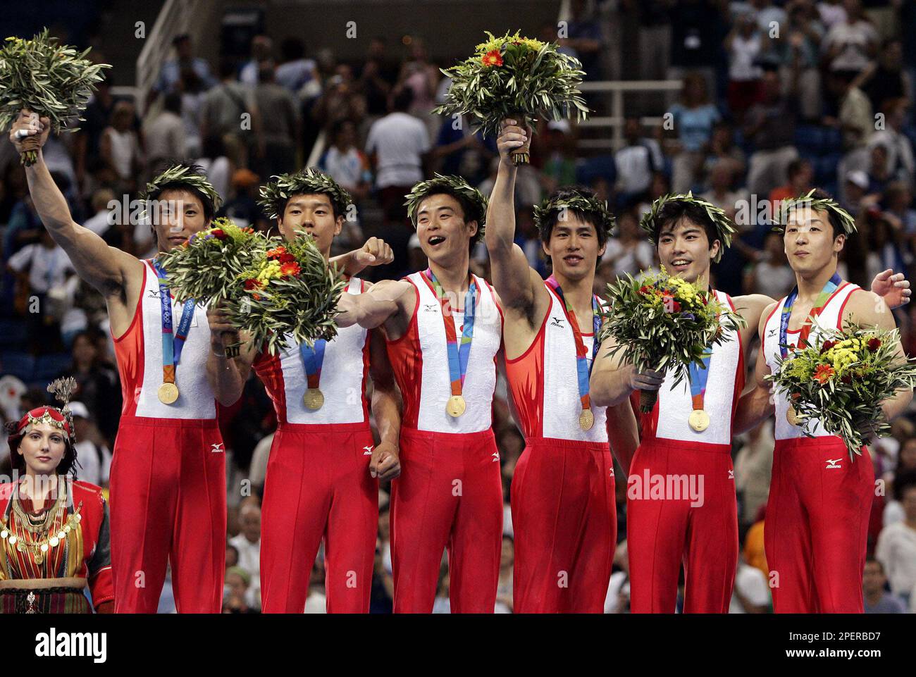 Japan's men's gymnastics team celebrates with their gold medals during