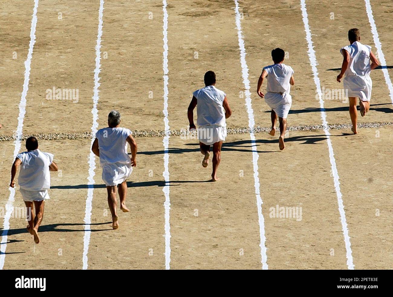 Barefoot runners wearing tunics take part in a footrace in the ancient ...