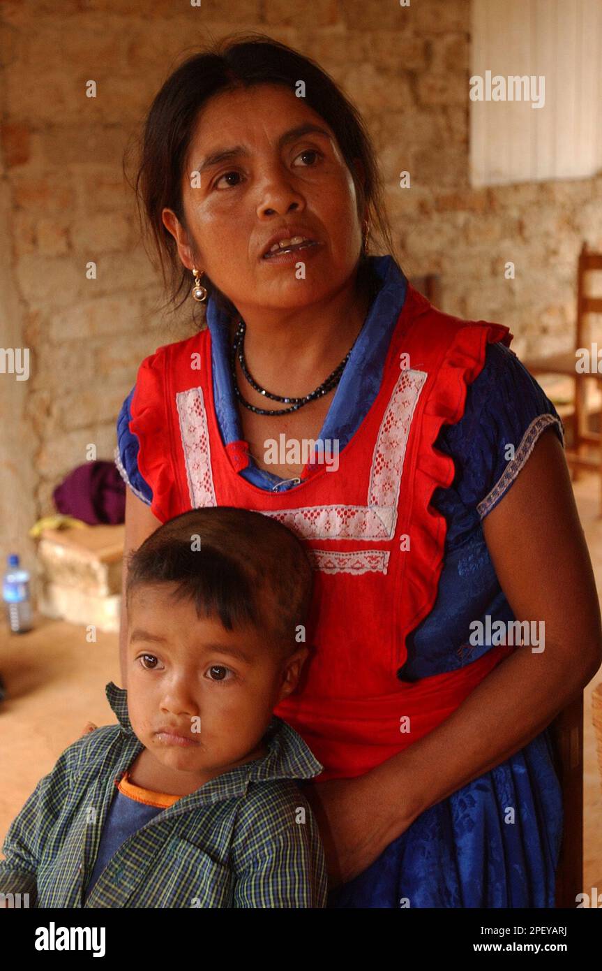 Ines Ramirez Perez, 44, and her son Orlando Ruiz Ramirez, 4, pose in their home in the town of Rio Talea, in the mountains of southern Mexico, May 20, 2004. In March 2000, Ramirez cut open her womb with a kitchen knife her husband used to slaughter animals and delivered Orlando in her rural home after problems developed during labor. According to an international medical report, this is the first recorded case of a self-inflicted C-section where both the mother and the child survived.(AP Photo/Jaime Puebla) Stockfoto