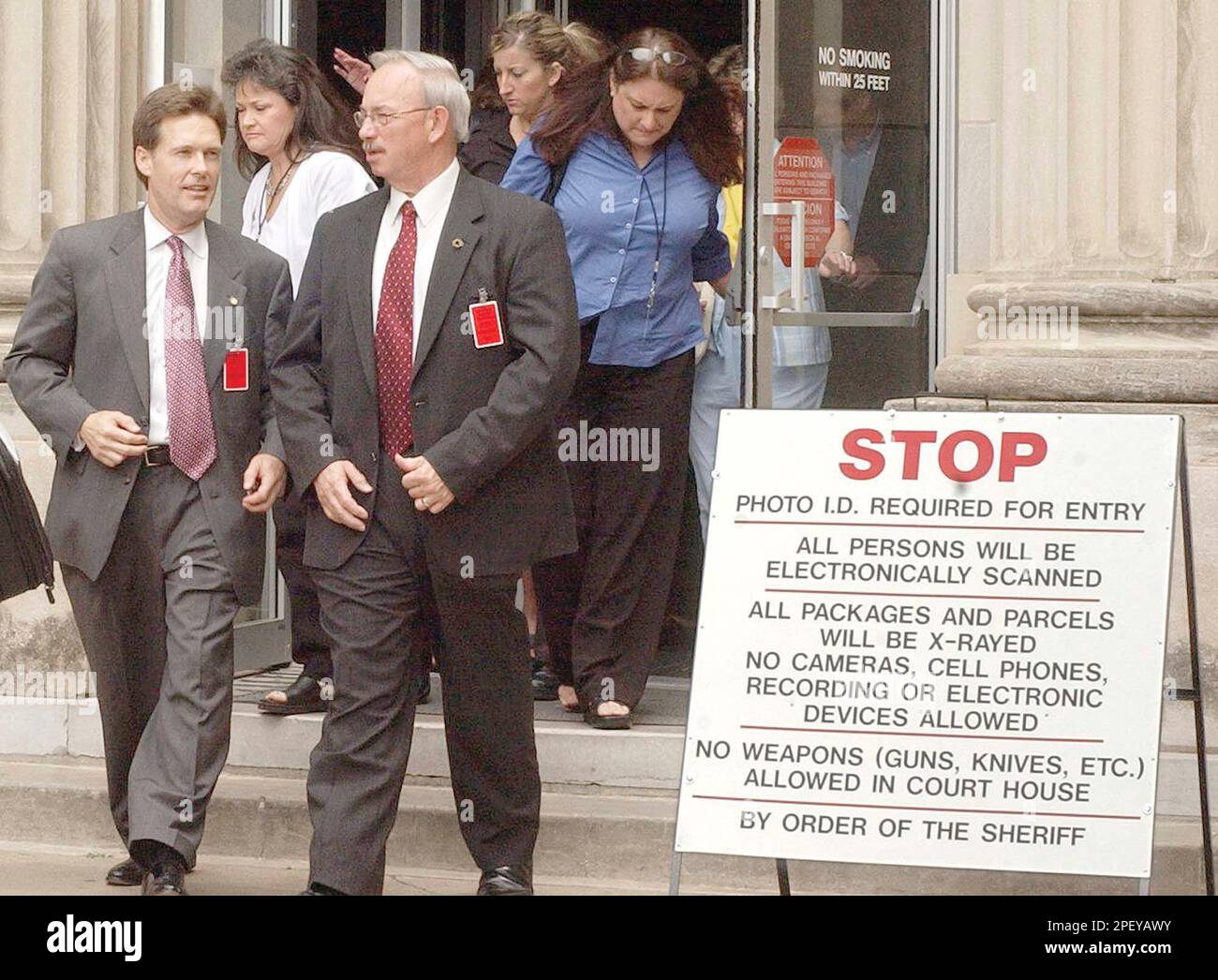 Oklahoma County District Attorney Wes Lane, left, leaves the Pittsburg