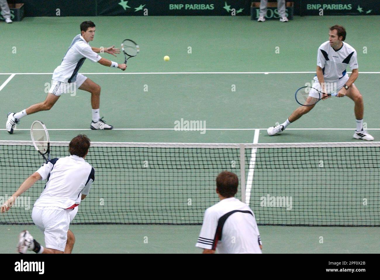 Britain's Greg Rusedski, right, watches as teammate Tim Henman returns