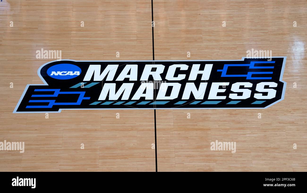 The March Madness logo is shown on the court before college basketball