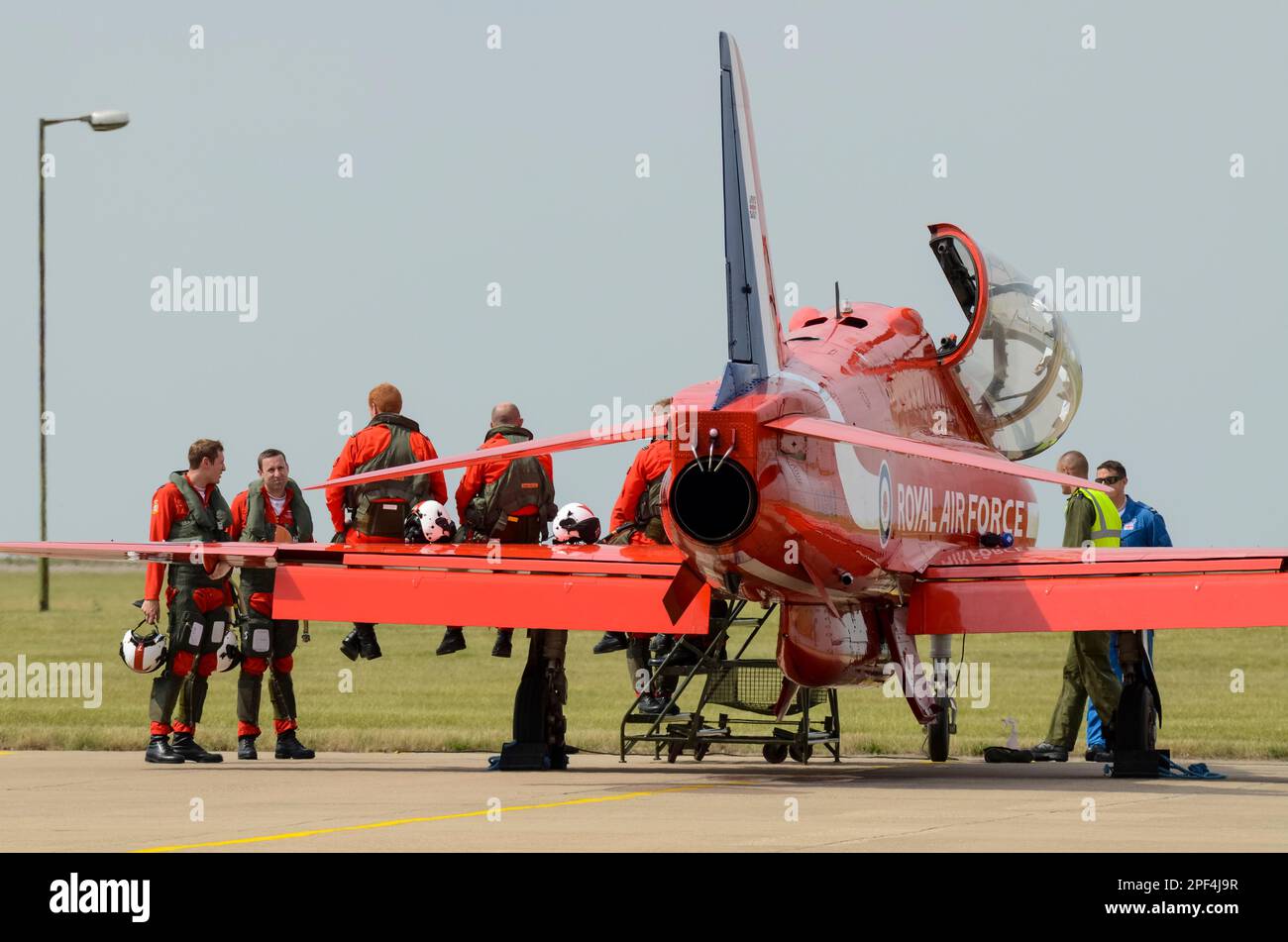 Royal Air Force, RAF Red Arrows zeigen Team-Piloten um ein Düsenflugzeug der BAE Hawk T1 nach einer Ausstellung auf der RAF Scampton, Großbritannien. Entspannt Stockfoto