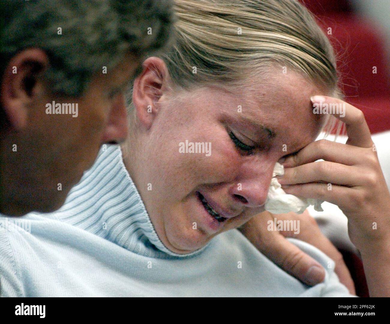 Caitlin Atwater, daughter of Kathleen Peterson, is comforted by her(02)