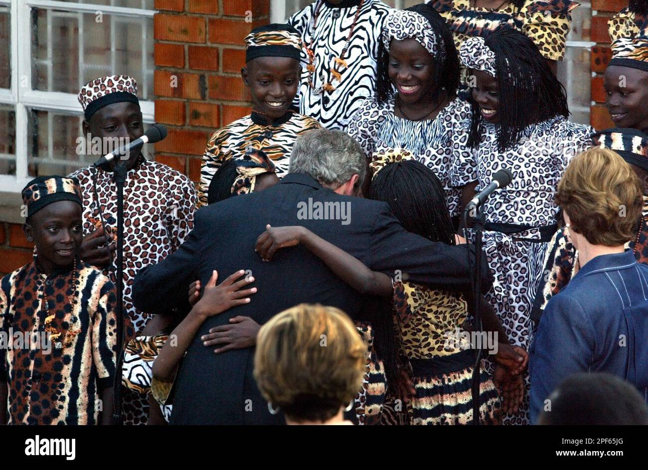 President Bush, center, hugs members of the Ugandan Watoto Children's