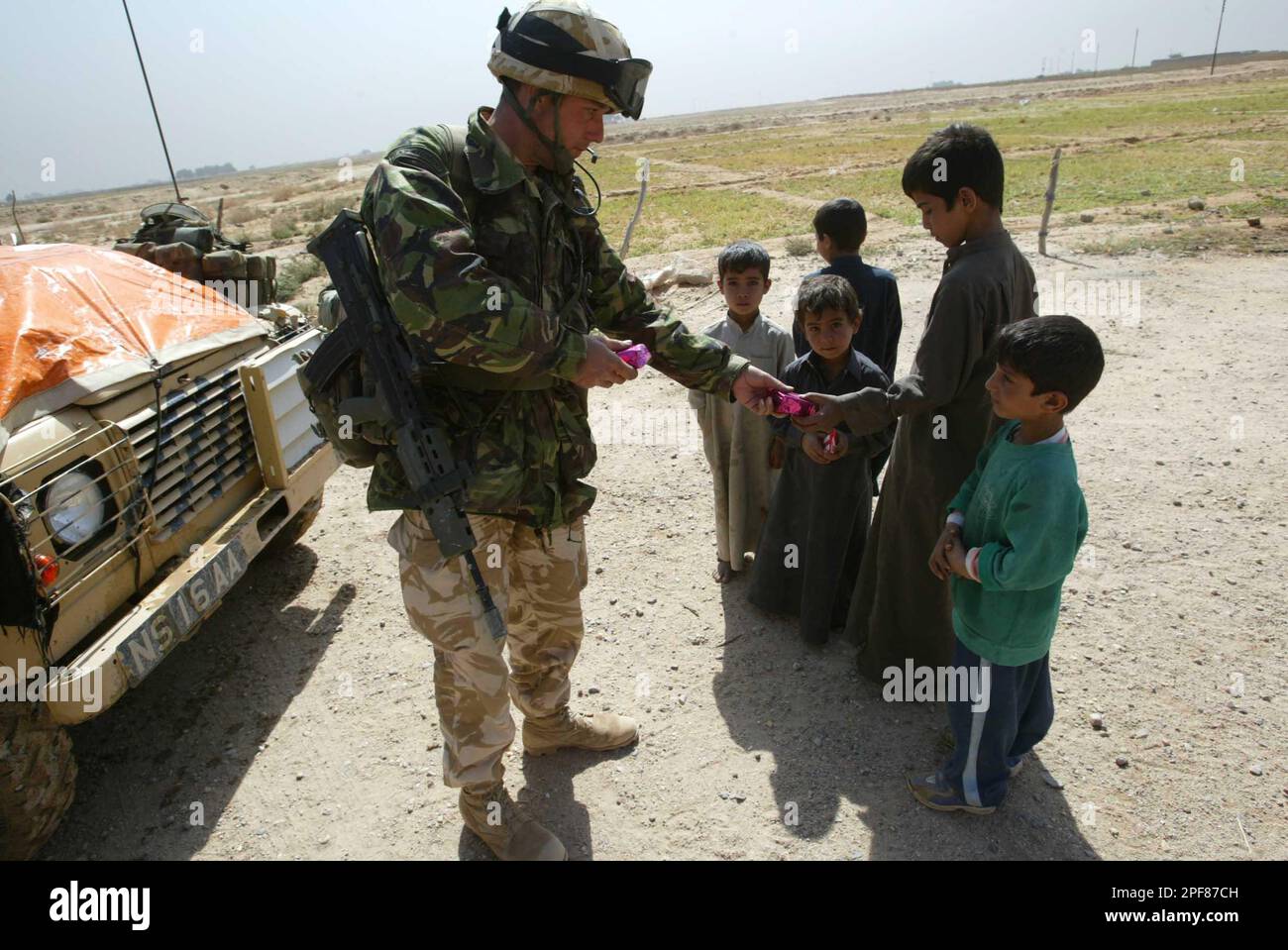 Corporal Nick Chapple, of RAF 51 Squadron, hands out his own rations to ...